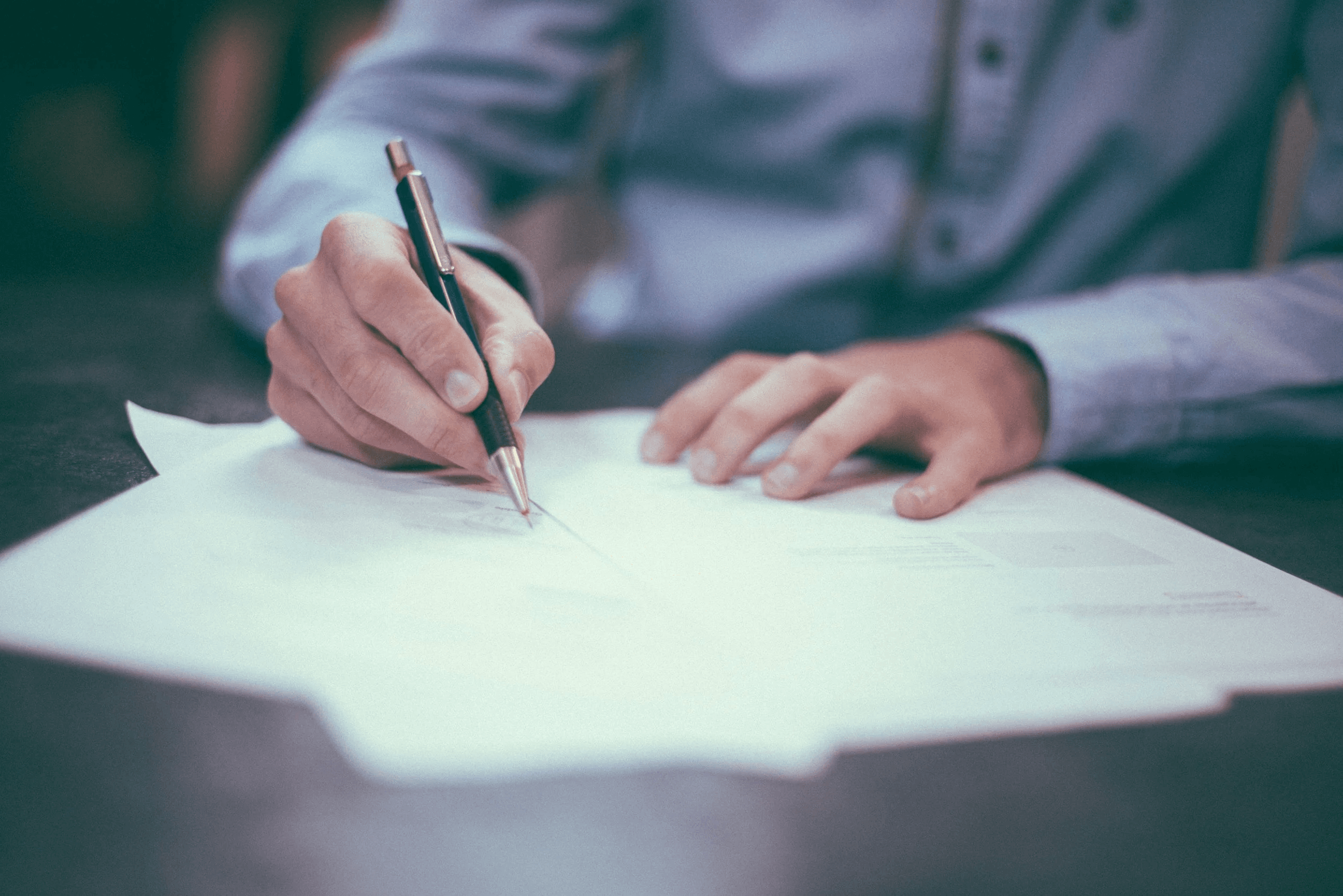 A person making notes on a printed document